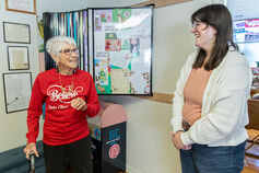 A student speaks with an older woman.
